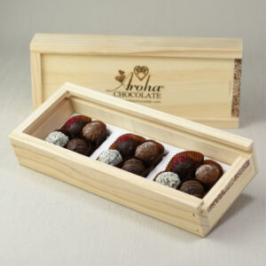 Aroha Chocolate Twelve Mixed Truffles Luxury Wooden Gift Box, in front an open box showing the beautiful hand rolled truffles and a closed box behind highlighting the over all look when received.