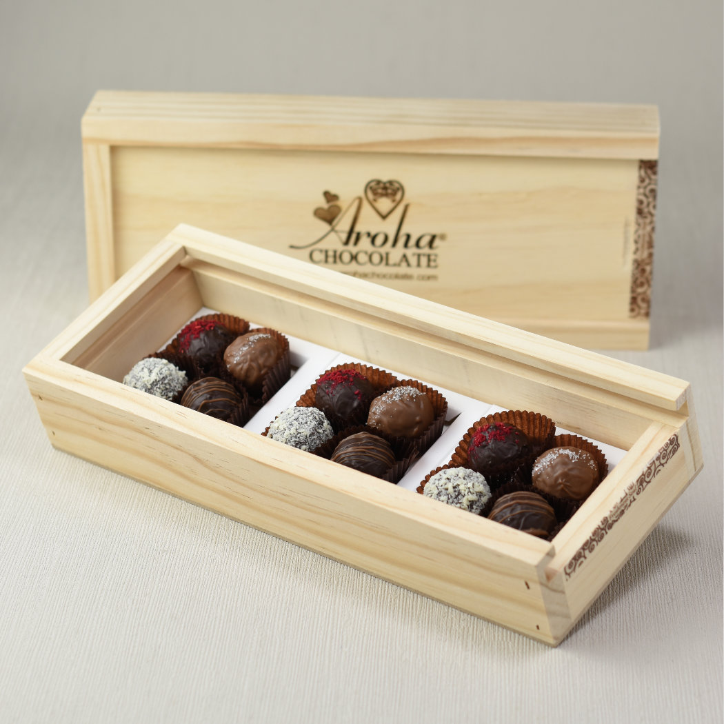 Aroha Chocolate Twelve Mixed Truffles Luxury Wooden Gift Box, in front an open box showing the beautiful hand rolled truffles and a closed box behind highlighting the over all look when received.